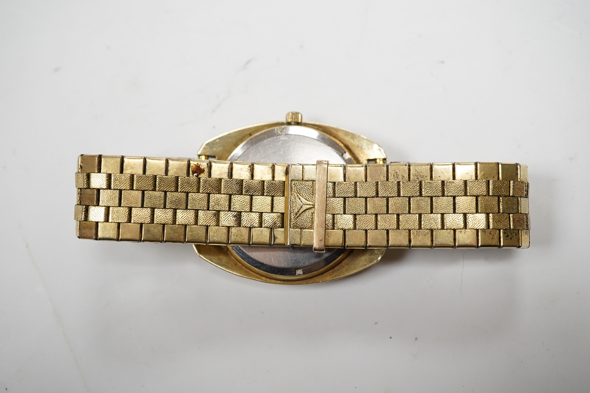 A gentleman's steel and gold plated Omega Constellation Electronic wrist watch, with baton numerals and day/date aperture, case diameter 38mm, on an associated gold plated strap. Condition - poor